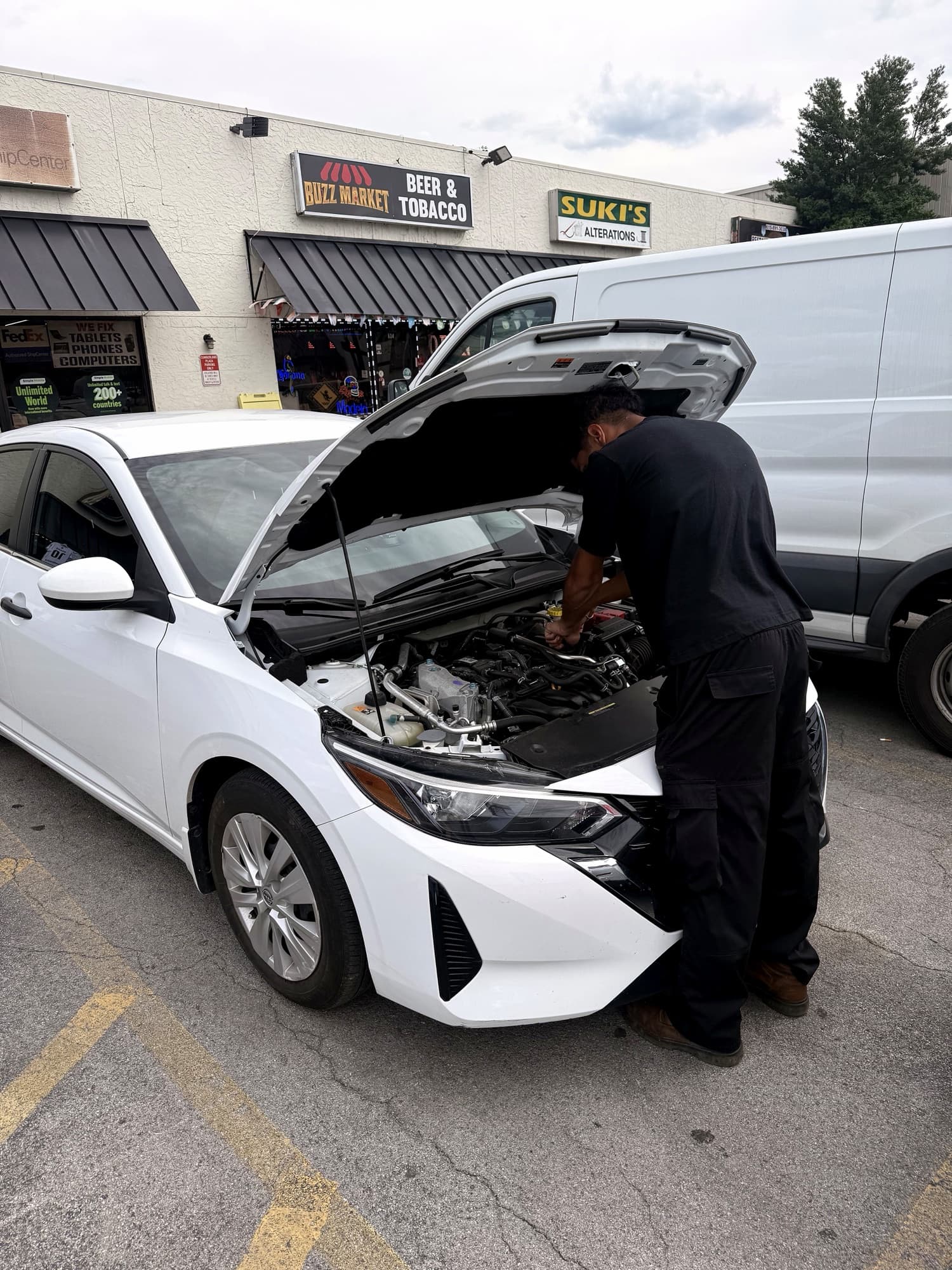 Omar Almasri working under the hood of a vehicle