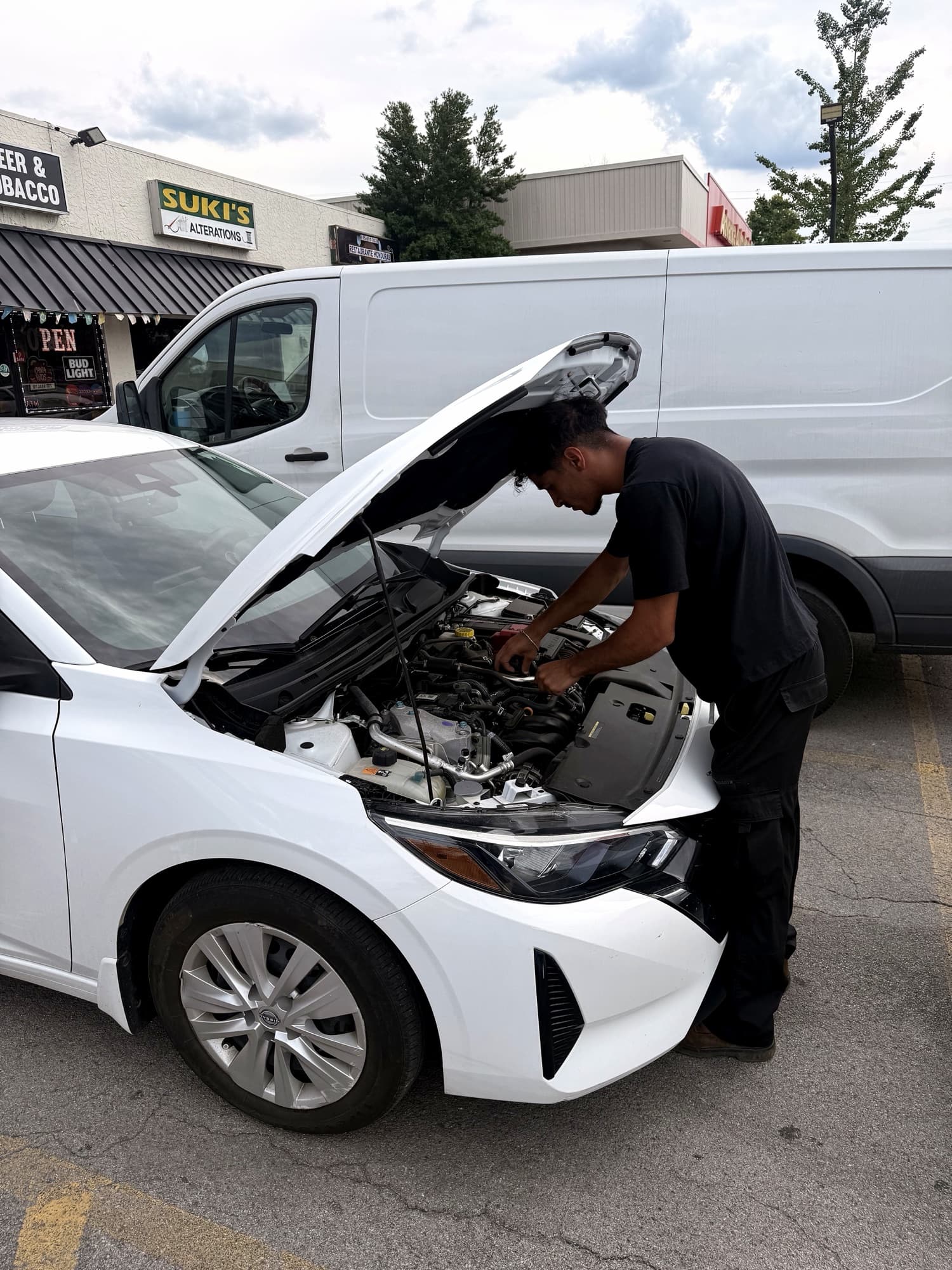 Omar Almasri working under the hood of a customer's vehicle